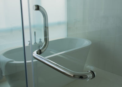 Soft focused picture of stainless steel handle with glass door in luxury bathroom